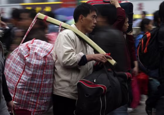 A worker makes his way to a&nbsp;train station in Guangzhou, China, on Wednesday. Some 210 million Chinese are expected to take the train during this year's Lunar New Year holiday.